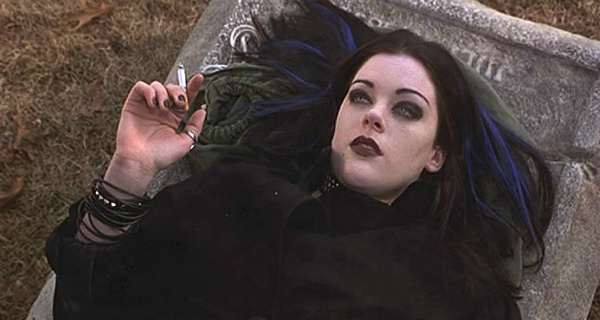 Kim (Kim Director) relaxes in a cemetery in Burkittsville, Maryland before heading out into the woods in search of the Blair Witch. 